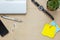 Top view notepaper,pen,,cactus,watch,mobile phone,paperclips,Laptop,earphones on office desk background.