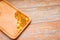 Top view of nutritional supplement gold capsules in wooden plate on wooden table