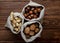 top view of nuts in sacks walnuts peanuts and hazelnuts in shell on wooden background