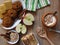 Top view. Oat cereal grain meal, baked and fresh apples, biscuits, yogurt and cinnamon on rustic style oak wood background.