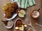 Top view. Oat cereal grain meal, baked and fresh apples, biscuits, yogurt and cinnamon on rustic style oak wood background.