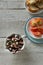 Top view of octopus salad with slices of toasted baguette and tomatoes on rustic wooden background