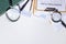 Top view of office desk. Business papers, pens, marketing plan, magnifying glass on the white background.Empty space for text