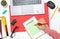 Top view of office desk with paper, stationery and tablet computer