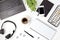 Top view of office desk. Table with laptop, conference speakerphone and office supplies. Flat lay home office workspace, remote