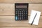 Top view office table calculator with pen and notebook on the table for business with copy space