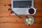 Top view of an office table with a laptop, cup of coffee and three rice cake muffin.