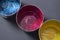 Top view of old CMYK paint cans on dark background. Colorful background.