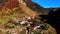 Top view of old houses in mountain valley in autumn. Footage. Beautiful landscape with old small village in mountain