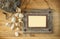 Top view of old nautical wooden frame and natural seashells on wooden table
