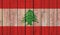 Top view of Old Painted Flag of Lebanon on Dark Wooden Fence, wall. patriot and travel concept. no flagpole. Flag background.