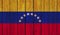 Top view of Old Painted Flag of Venezuela on Dark Wooden Fence, wall. patriot and travel concept. no flagpole. Flag background.