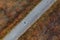 Top view of old worn road through grassy autumn meadow