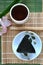 Top View of Onigiri with Tea on Bamboo Mat