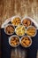 Top view of onion rings, cheese balls, chicken nuggets, wings in batter, fries and cheese sticks. Six-course set in paper buckets