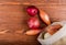 top view of onions spilling out of sack on wooden background with copy space