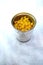 Top view of open corn can on a white tablecloth