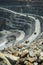 Top view, open pit work. Large quarry dump trucks