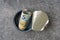 Top view of open tin can with a roll of Euro banknotes