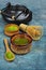 Top view on organic green matcha teaï¿½in bowls with bamboo whisk and traditional black asian kettle