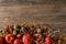 top view of organic pomegranates, apples and walnuts on wooden tabletop