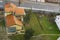 Top view outskirts private house with neighbor playground for children and car road