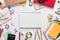 Top view over a school supplies as calculator, rulers, tapes, paper clips, notebooks and other stuff placed in a circle on a white