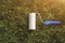 Top view of a paint roller with an blue handle, that is painting a grassy strip using lawn as color. Ecological concept