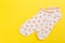 Top view of a pair of colored socks on a yellow background. Clothing in the form of socks