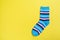 Top view of a pair of colored socks on a yellow background. Clothing in the form of socks