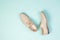 Top view of a pair of light summer men`s shoes on a light blue background.