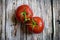 Top view of a pair of red tomatoes on wood table