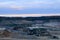 Top view panorama of deep kaolin strip mine with dumper trucks and cranes. Quarry for the extraction of minerals.