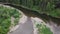 Top view of panorama of river passing through forest. Stock footage. Beautiful view of river reflecting sky and