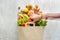 Top view paper bag different health food white wooden background