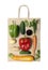 Top view on a paper bag with vegetables, peppers, cucumbers, carrots, onions, zucchini, ginger and basil. The concept of buying