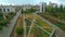 Top view of park alley in residential area of city. Clip. View of city with residential buildings and park alley