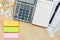 Top view of passbooks saving account, calculator, notebook with pen, pile of coins and colorful sticky notes on wood background