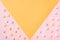 Top view of the pastel marshmallows on a pink and yellow background. Minimal style.