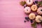 Top view of pastel mini pumpkins with leaves and berries, artfully arranged on a serene blush pink textured backdrop. Autumn