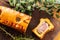 Top view of a pate en croute or pÃ¢tÃ© en croÃ»te with rosemary twig and green olives branch over a dark wooden cutting board.