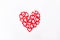 Top view patterned big shape of a heart made of wooden cutting red hearts on the white background. Valentine`s day, love