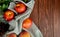 top view of peaches and pinecones on cloth on left side and wooden background with copy space