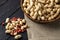 top view peanuts in shell in a basket with peeled on a black wooden table