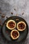 top view pecan tarts on a grey plate