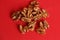 Top view of peeled walnuts on red background