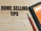 Top view pen,calculator and book with text HOME SELLING TIPS written on wooden background.B