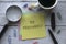 Top view of pen, magnifying glass, a cup of coffee and memo notes written with Be Prepared on white wooden background