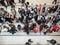 Top view of people gazing at their mobile phones whilst standing in a queue in Arndale  Shopping in Manchester