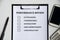 Top view of performance Appraisal checklist on clip board with white background.